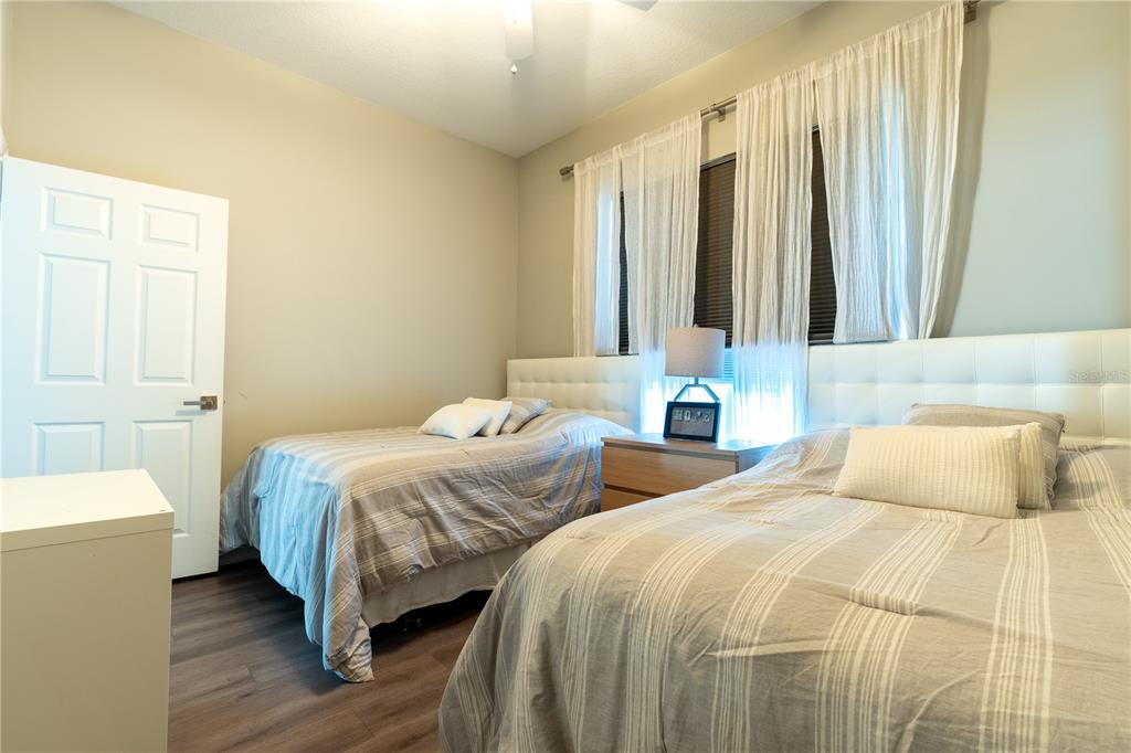 930 Spring Park Street, Unit 103 Kissimmee, FL 34747 - Photo 32 of 40 a bedroom with two beds and a window