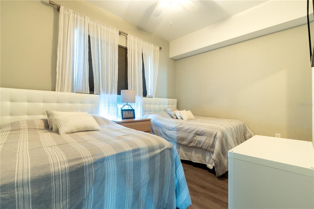 930 Spring Park Street, Unit 103 Kissimmee, FL 34747 - Photo 33 of 40 a bedroom with two beds and a window
