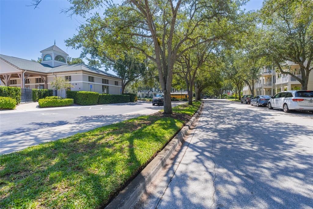 930 Spring Park Street, Unit 103 Kissimmee, FL 34747 - Photo 36 of 40 a front view of a house with a garden and trees