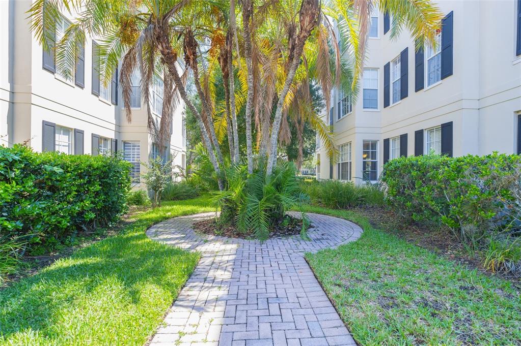 930 Spring Park Street, Unit 103 Kissimmee, FL 34747 - Photo 38 of 40 a view of a building with a garden