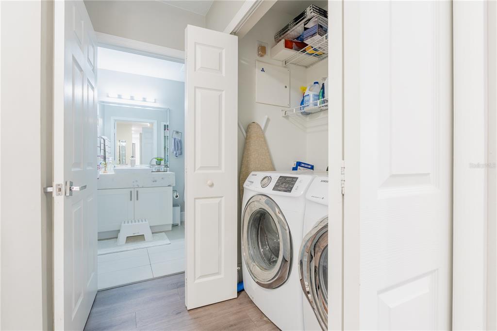 930 Spring Park Street, Unit 103 Kissimmee, FL 34747 - Photo 8 of 40 a view of a hallway with washer and dryer
