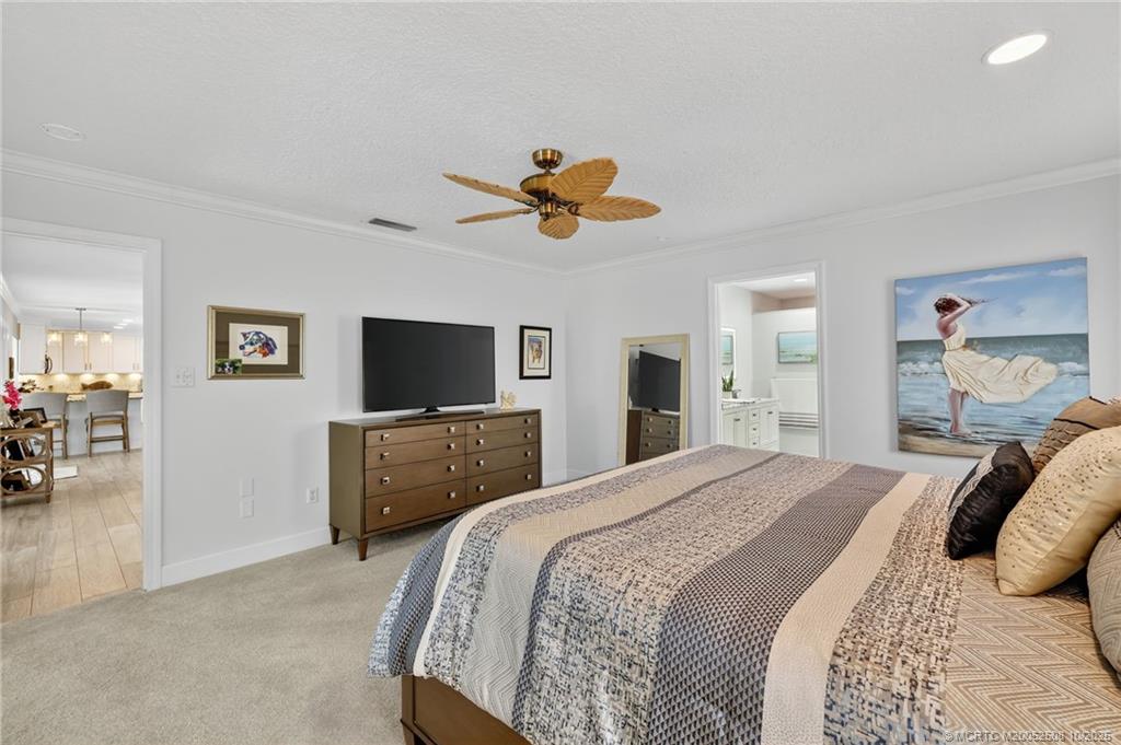 3353 Southeast Fairway East Stuart, FL 34997 - Photo 13 of 55 a bedroom with a bed and a flat screen tv