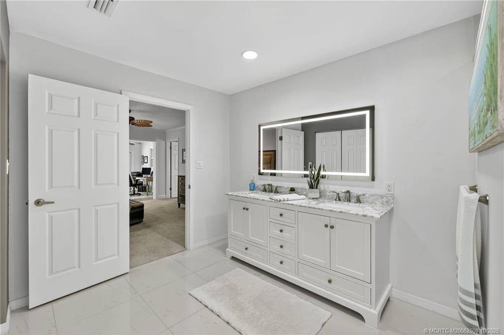 3353 Southeast Fairway East Stuart, FL 34997 - Photo 16 of 55 a bathroom with a double vanity sink mirror and