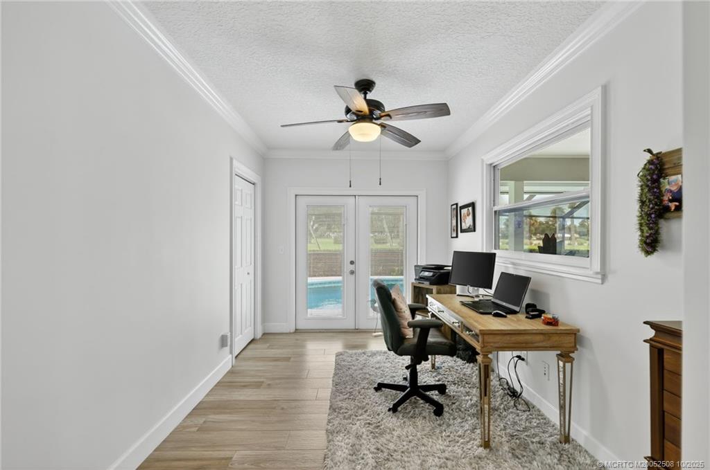 3353 Southeast Fairway East Stuart, FL 34997 - Photo 18 of 55 a workspace with chandelier fan and a window