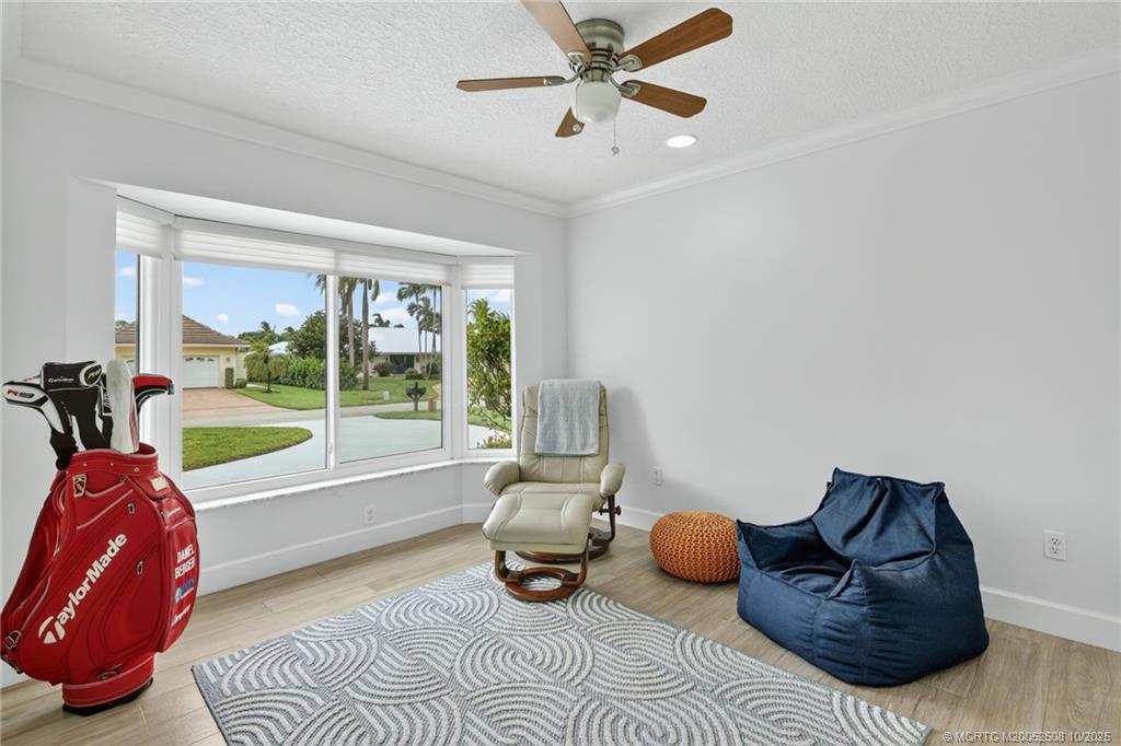 3353 Southeast Fairway East Stuart, FL 34997 - Photo 21 of 55 a living room with furniture floor to ceiling window and a potted plant