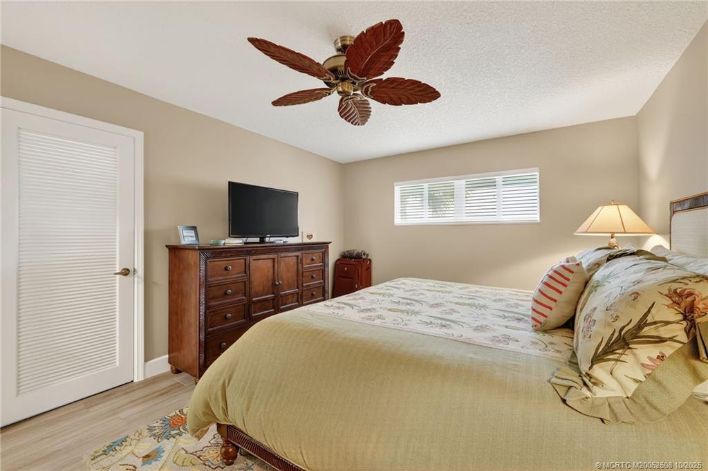3353 Southeast Fairway East Stuart, FL 34997 - Photo 24 of 55 a bedroom with a bed and a flat screen tv
