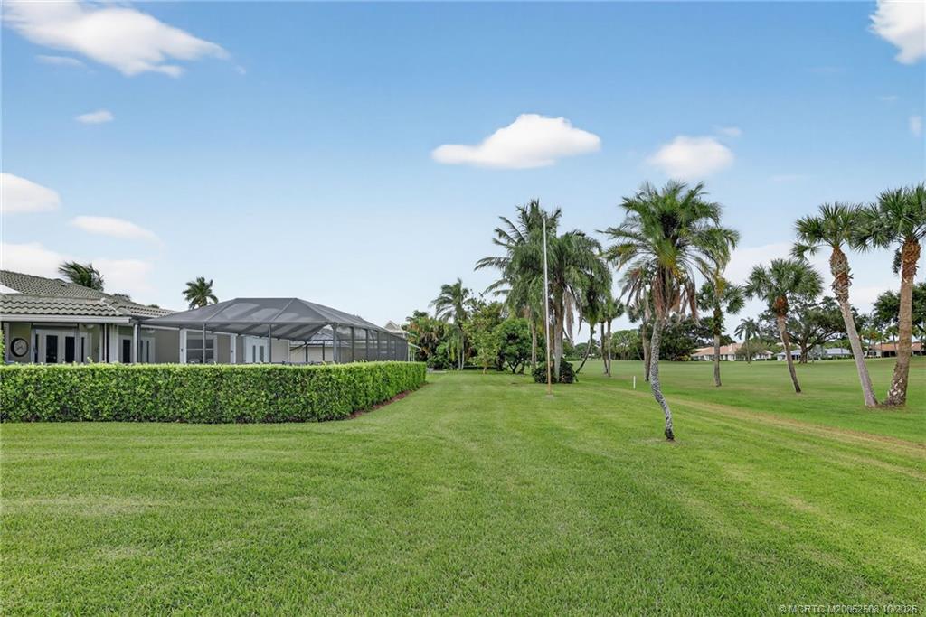 3353 Southeast Fairway East Stuart, FL 34997 - Photo 39 of 55 a view of a big house with a big yard and palm trees