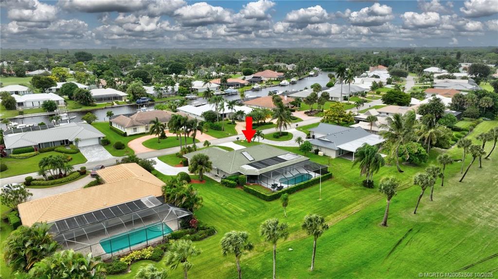 3353 Southeast Fairway East Stuart, FL 34997 - Photo 49 of 55 an aerial view of a house with a yard and lake view in back