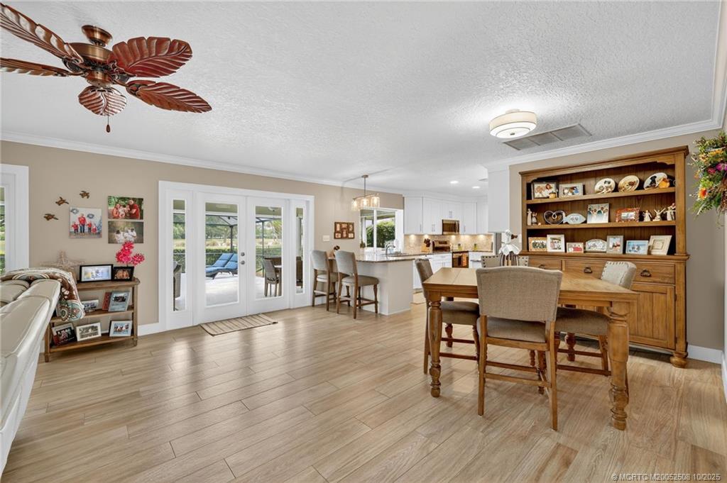 3353 Southeast Fairway East Stuart, FL 34997 - Photo 5 of 55 a view of a a dining room with furniture and wooden floor