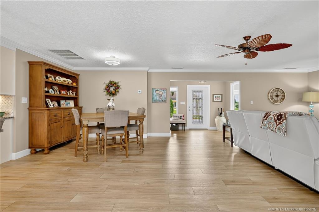 3353 Southeast Fairway East Stuart, FL 34997 - Photo 6 of 55 a view of a livingroom with furniture and a kitchen