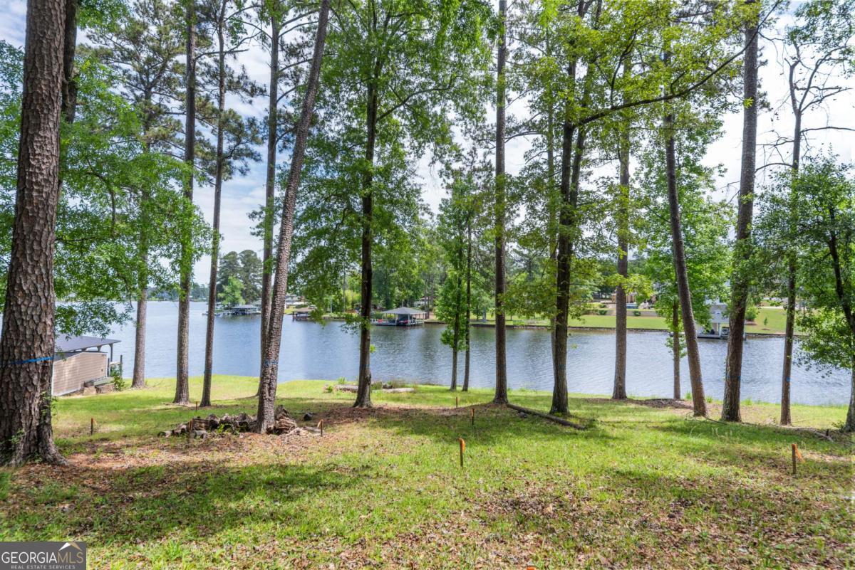 151 Bill Johnson Road Northeast Milledgeville, GA 31061 - Photo 21 of 27 a backyard of a house with swimming pool and large trees