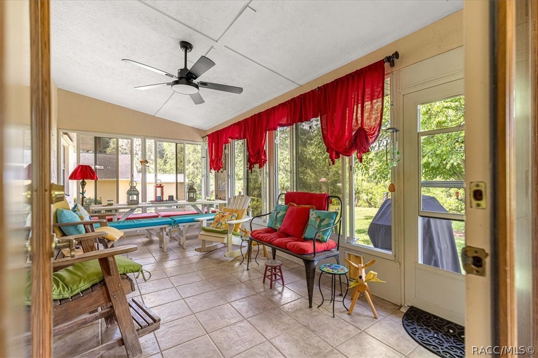 2964 South Cygnet Terrace Inverness, FL 34450 - Photo 21 of 67 a living room with furniture a rug and a floor to ceiling window