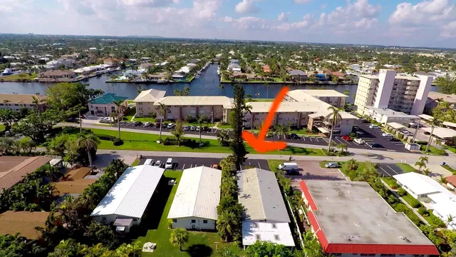 an aerial view of residential houses with outdoor space and swimming pool