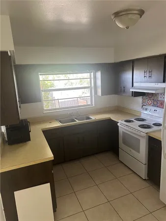 a kitchen with a stove a sink and a refrigerator