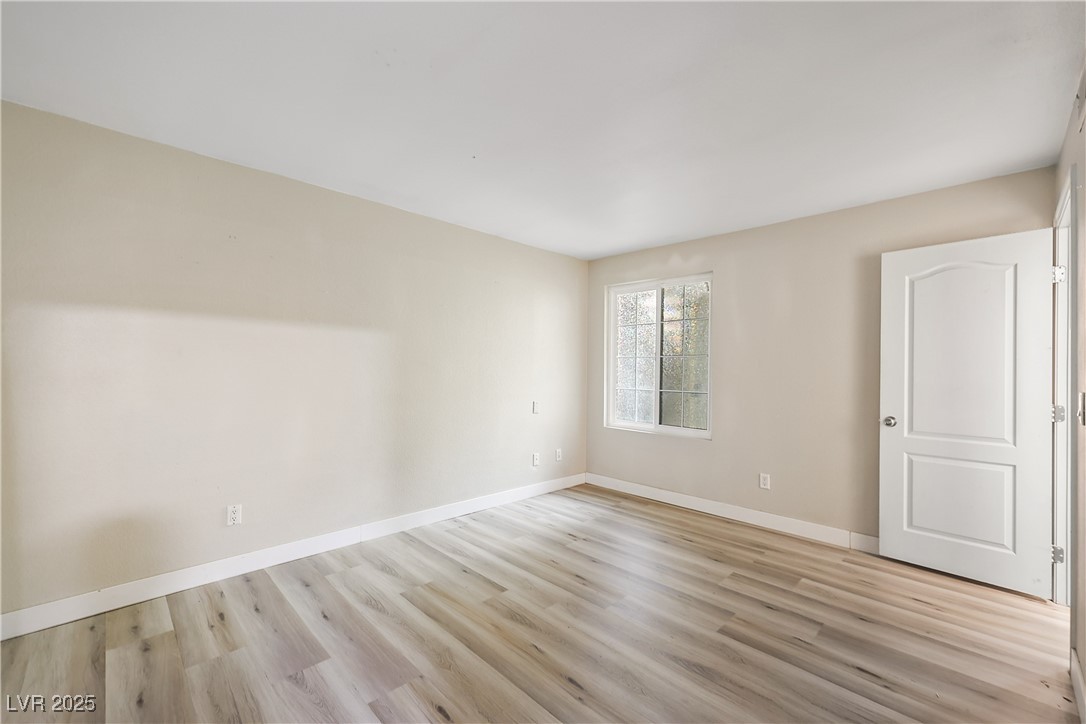 3145 East Flamingo Road, Unit 1123 Las Vegas, NV 89121 - Photo 14 of 30 Empty room with light wood-style floors and baseboards