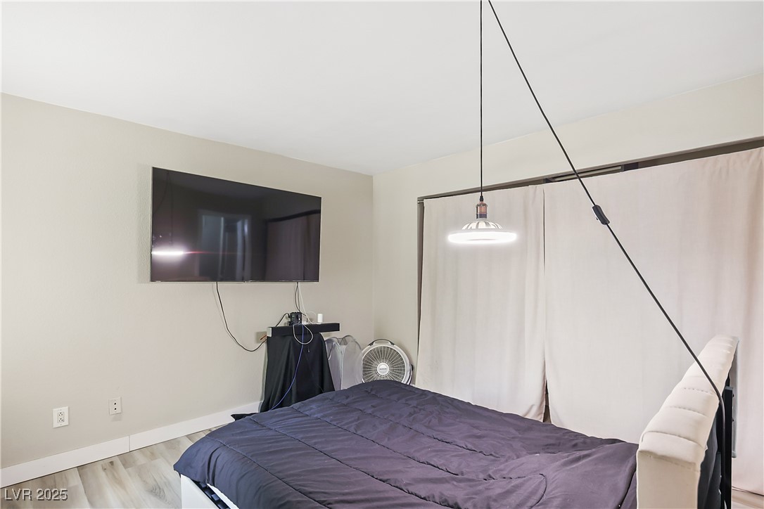 3145 East Flamingo Road, Unit 1123 Las Vegas, NV 89121 - Photo 17 of 30 Bedroom with baseboards and wood finished floors