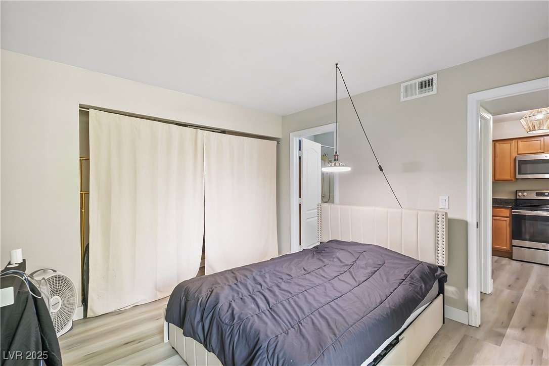 3145 East Flamingo Road, Unit 1123 Las Vegas, NV 89121 - Photo 18 of 30 Bedroom featuring light wood finished floors