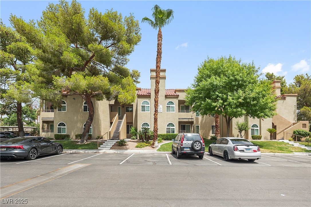 3145 East Flamingo Road, Unit 1123 Las Vegas, NV 89121 - Photo 30 of 30 View of building exterior with uncovered parking and stairway