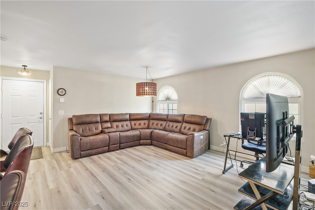 3145 East Flamingo Road, Unit 1123 Las Vegas, NV 89121 - Photo 5 of 30 Living area featuring light wood finished floors and baseboards