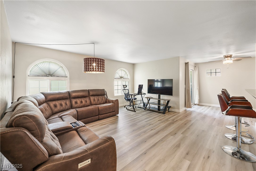 3145 East Flamingo Road, Unit 1123 Las Vegas, NV 89121 - Photo 7 of 30 Living area with light wood-type flooring and ceiling fan