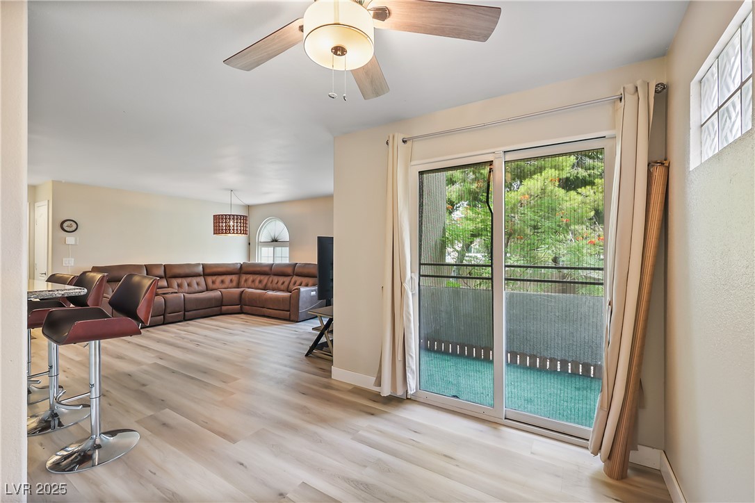 3145 East Flamingo Road, Unit 1123 Las Vegas, NV 89121 - Photo 9 of 30 Living room with light wood-style floors and ceiling fan