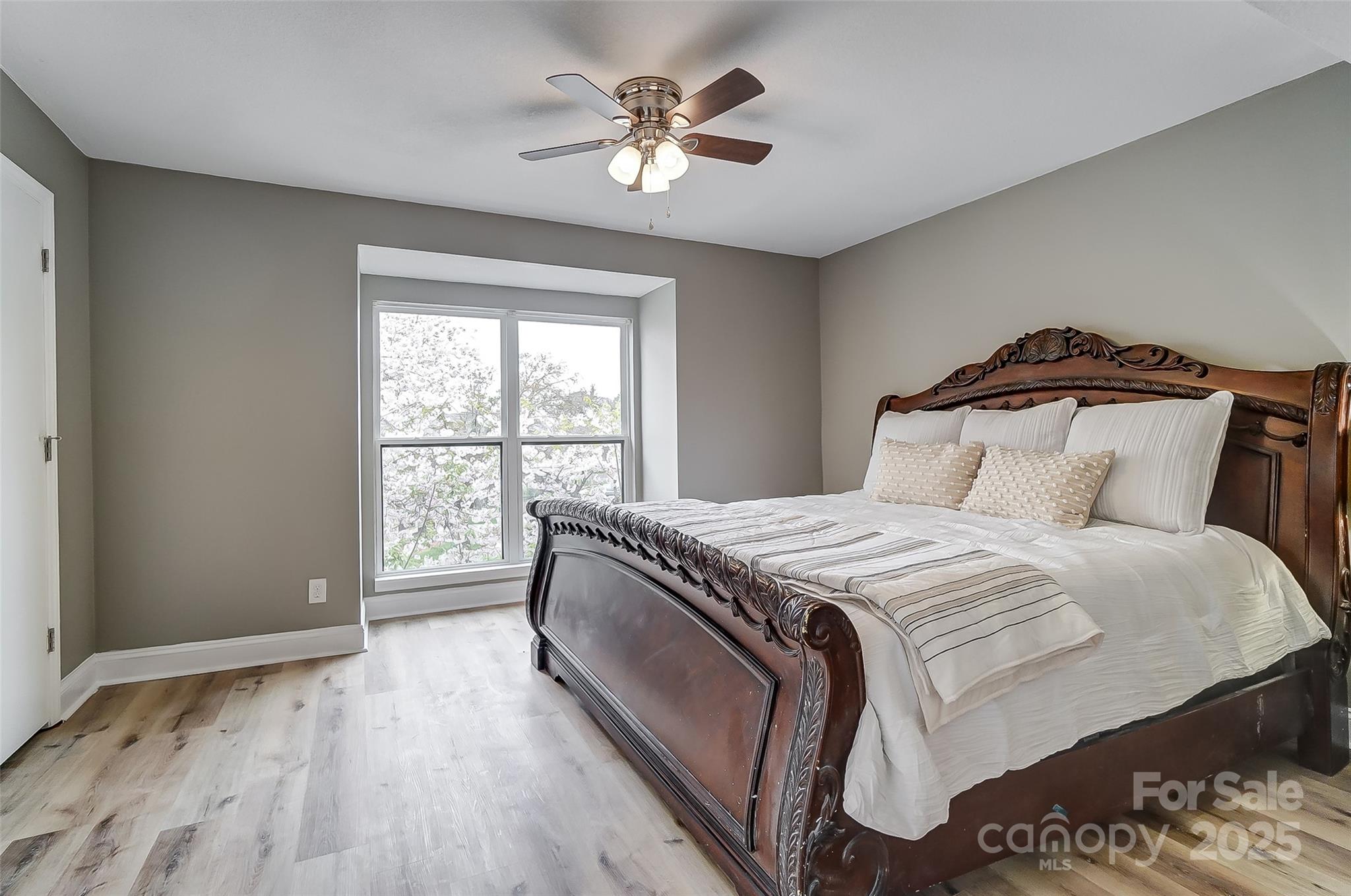 11039 Harrowfield Road Charlotte, NC 28226 - Photo 13 of 19 a bedroom with a large bed and a ceiling fan