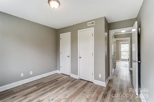 a view of an empty room and wooden floor