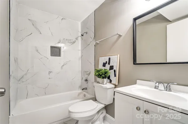 a bathroom with a sink toilet a mirror and shower