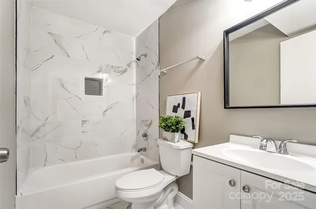 a bathroom with a sink toilet a mirror and shower