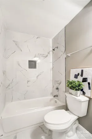 a bathroom with a toilet a sink and bathtub