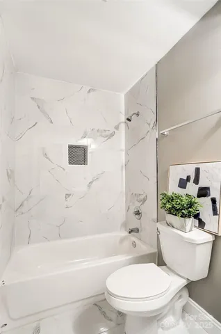 a bathroom with a toilet a sink and bathtub