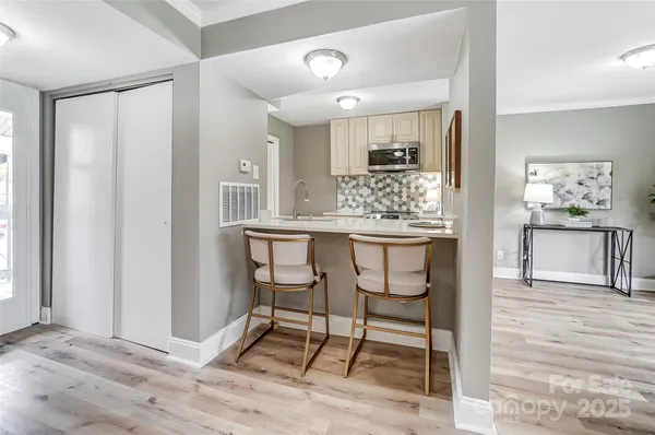 a living room with granite countertop furniture and a wooden floor
