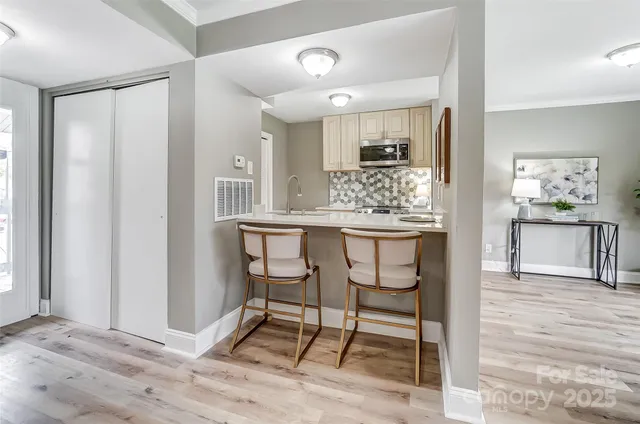 a living room with granite countertop furniture and a wooden floor
