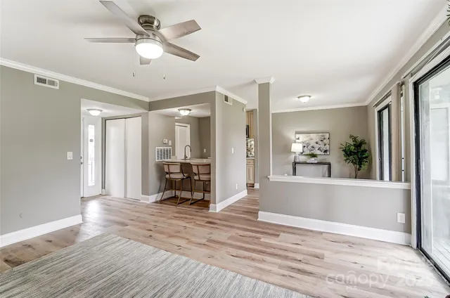 a view of a livingroom with furniture window and wooden floor