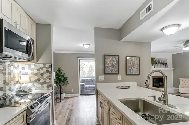 a kitchen with a sink stove top oven and microwave