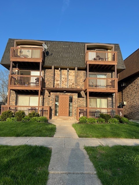 14747 Kenton Avenue, Unit 2A Midlothian, IL 60445 - Photo 1 of 16 a view of a building with a street sign