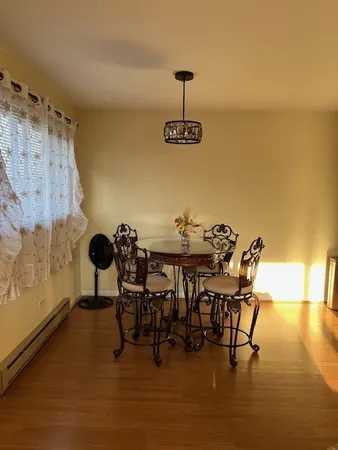 a view of a dining room with furniture and wooden floor
