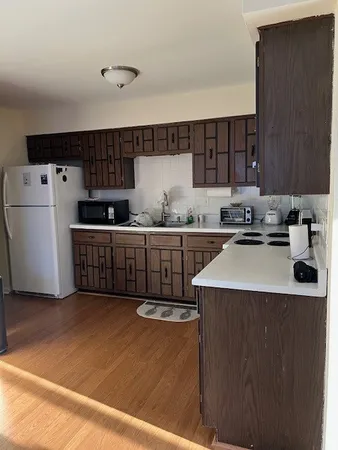 a kitchen with stainless steel appliances a sink a stove a refrigerator cabinets and a counter top space