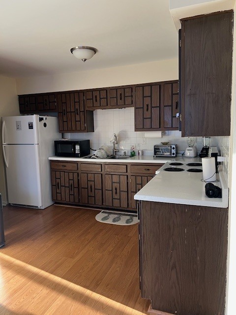 14747 Kenton Avenue, Unit 2A Midlothian, IL 60445 - Photo 8 of 16 a kitchen with stainless steel appliances a sink a stove a refrigerator cabinets and a counter top space
