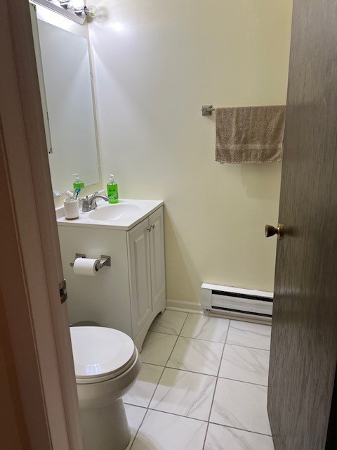 14747 Kenton Avenue, Unit 2A Midlothian, IL 60445 - Photo 10 of 16 a bathroom with a sink a toilet and shower