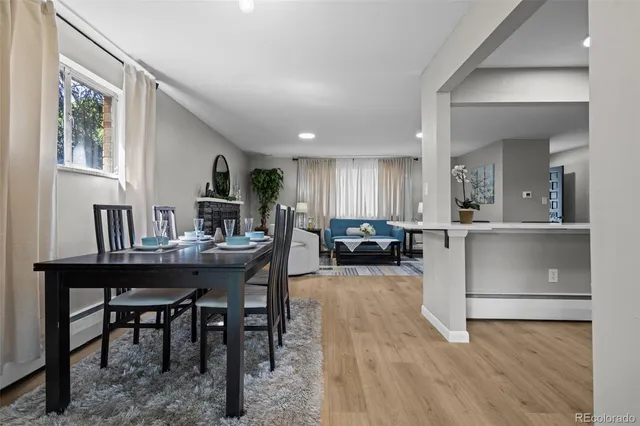 a view of a a dining room with furniture window and wooden floor