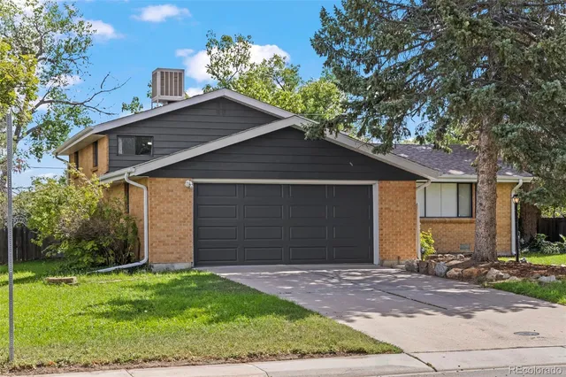 a front view of house with a garden