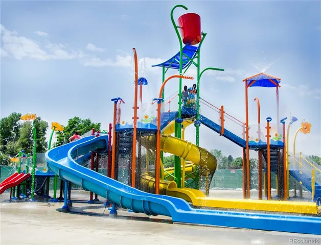 a front view of a house with a garden and trees