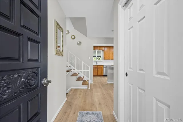 a hallway with wooden cabinets and a stove top oven