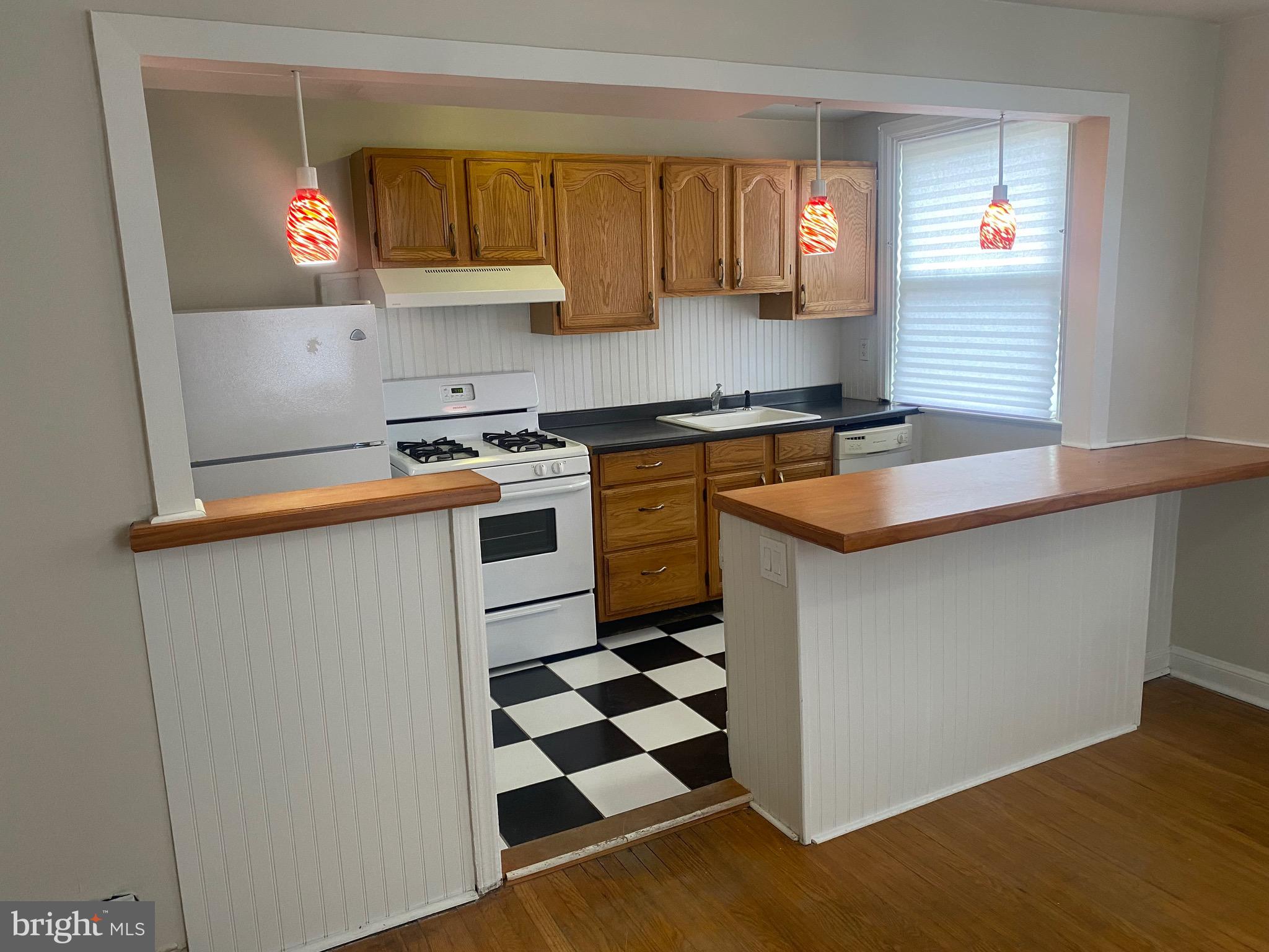 4019 Hellerman Street Philadelphia, PA 19135 - Photo 12 of 12 a kitchen with a sink a stove and cabinets