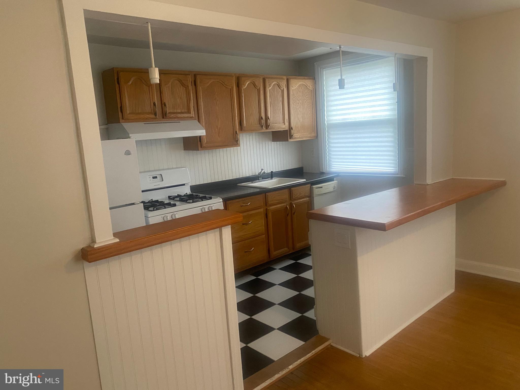 4019 Hellerman Street Philadelphia, PA 19135 - Photo 4 of 12 a kitchen with stainless steel appliances granite countertop a sink and a stove
