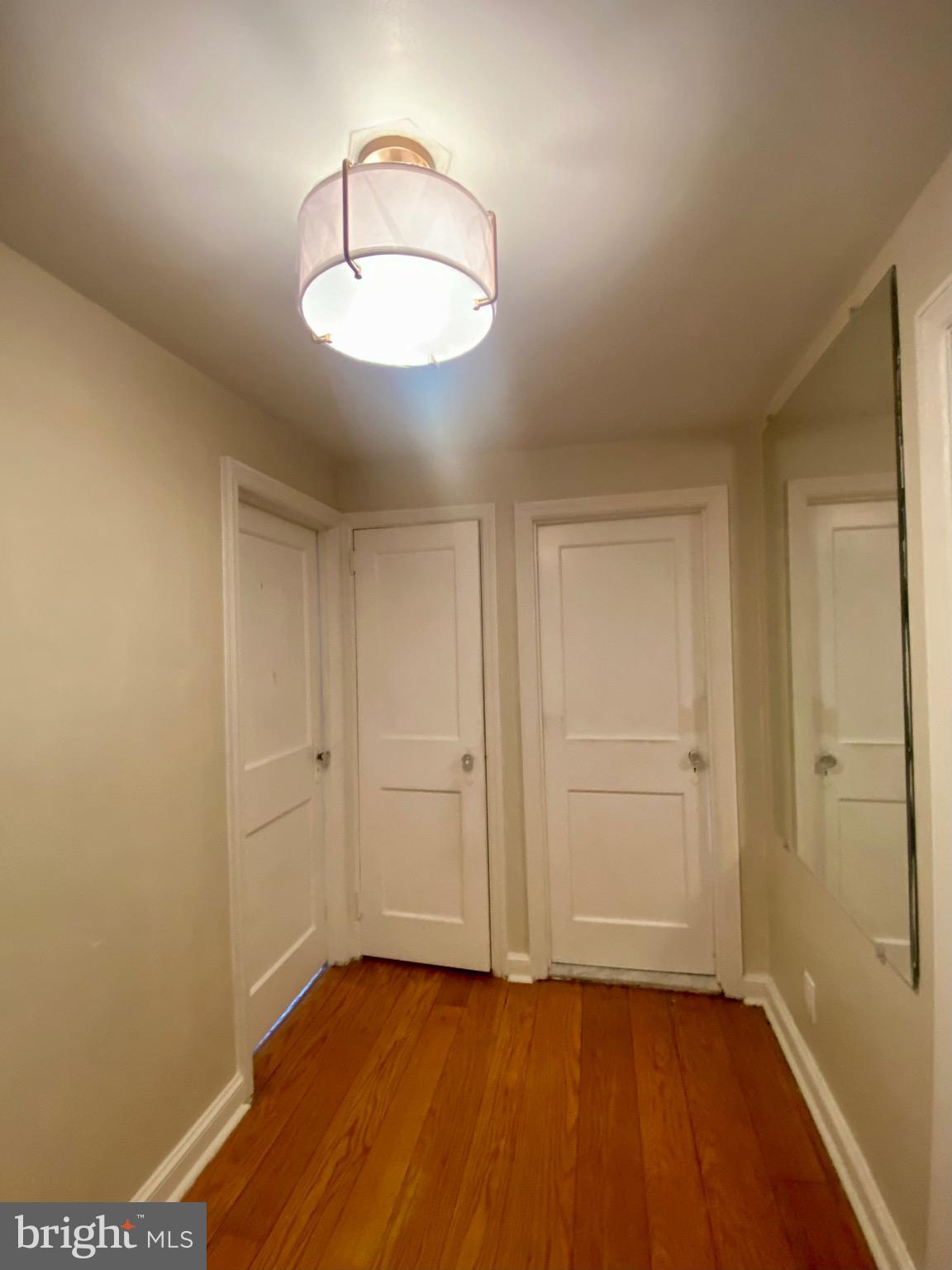 4019 Hellerman Street Philadelphia, PA 19135 - Photo 7 of 12 an empty room with wooden floor and windows