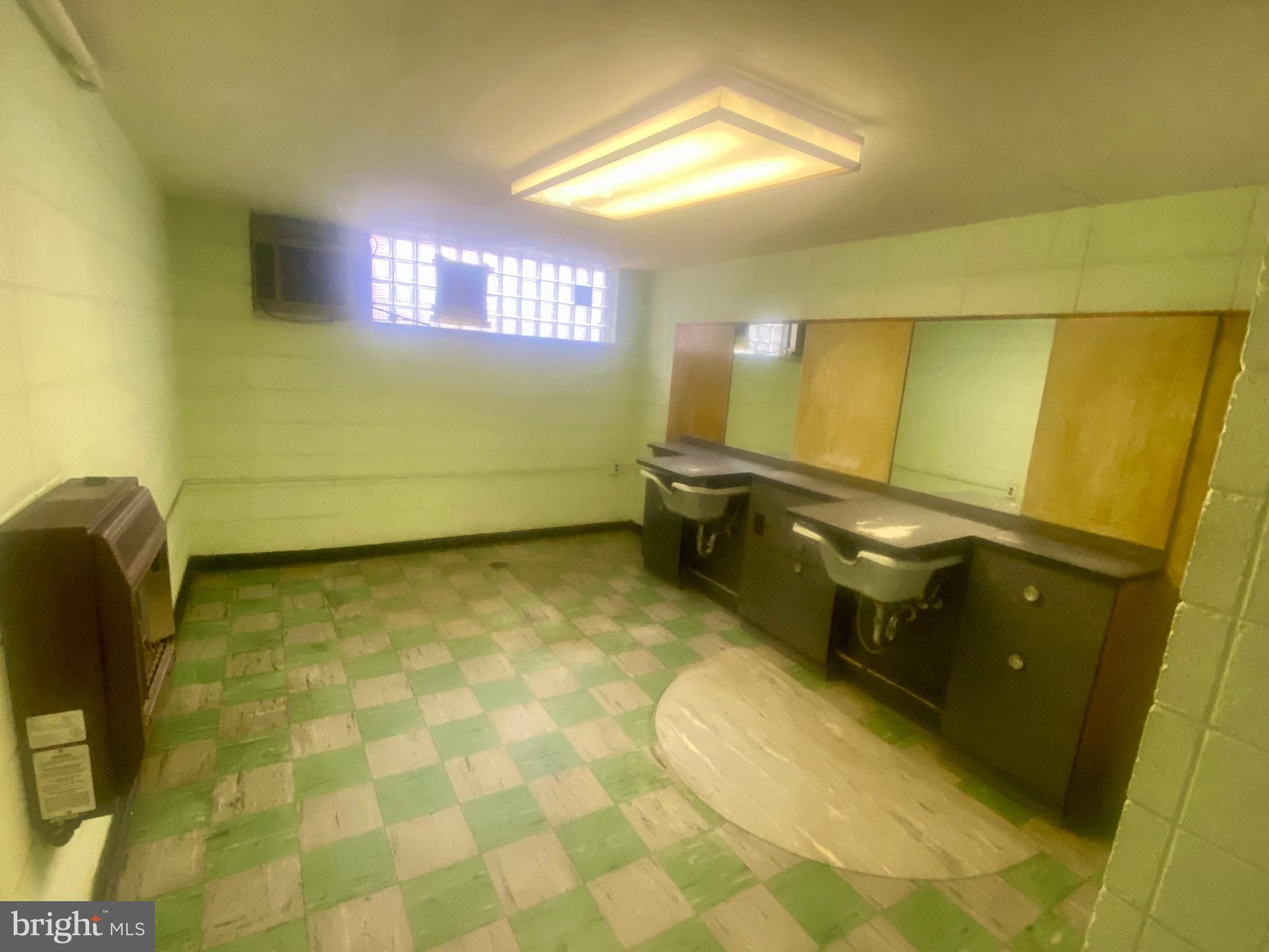 4019 Hellerman Street Philadelphia, PA 19135 - Photo 9 of 12 a bathroom with a sink and a mirror
