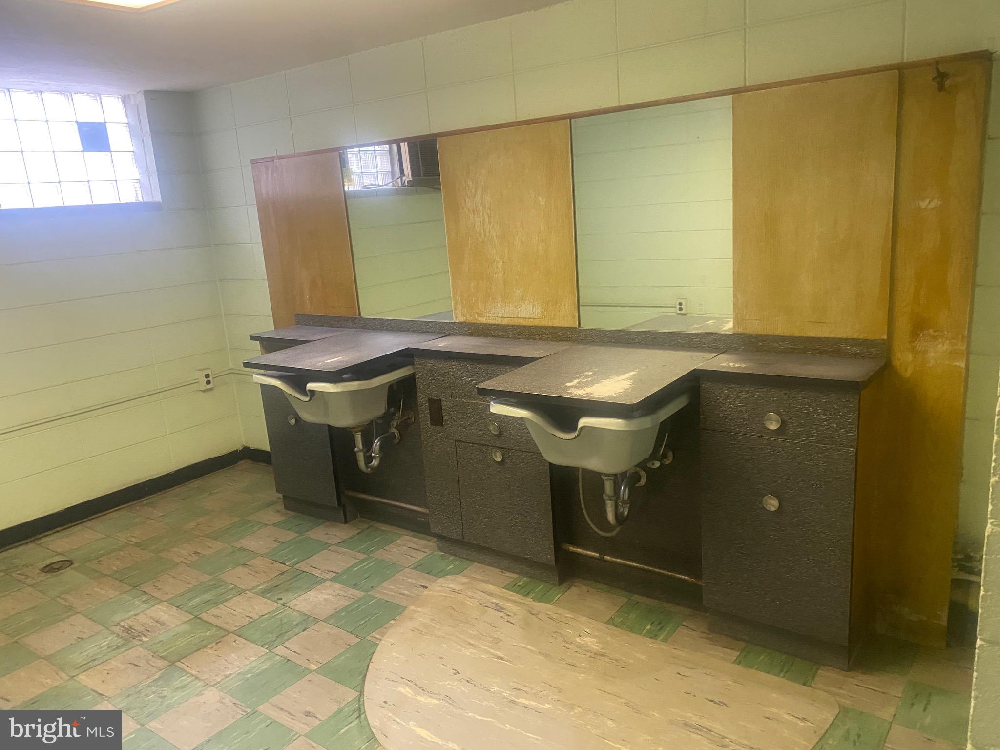 4019 Hellerman Street Philadelphia, PA 19135 - Photo 10 of 12 a bathroom with a sink and a mirror