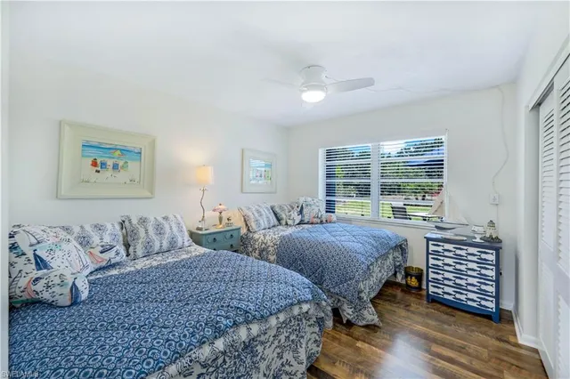 a bedroom with two beds and a large window